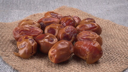 Dates in wooden bowl on background. dried dates fruit.