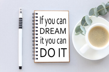 If you dream it, you can do. text on white notepad paper. near cups with coffee and plants on a gray background.