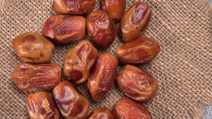 Dates in wooden bowl on background. dried dates fruit.