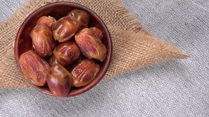 Dates in wooden bowl on background. dried dates fruit.