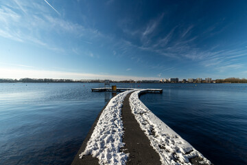 Pier on lake with snow
