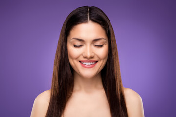 Portrait of attractive dreamy cheerful woman perfect clear pure make-up tone skin isolated over bright violet purple color background