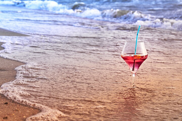 Wine glass with a cocktail by the sea.