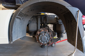 Traction axle of a truck without the wheels, where the brake disc and the suspension balloons can...
