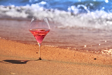 Wine glass with a cocktail by the sea.