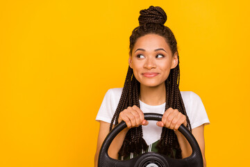 Photo of dreamy happy afro american young woman look empty space drive car isolated on yellow color...