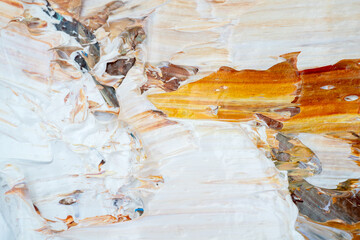 Embossed pasty oil paints and reliefs. Primary colors: ocher, white, yellow.  Abstract art.