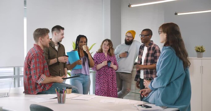 Diverse group of business people working in creative office.