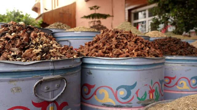 Traditional Moroccan herbal tea mixture in a street market in Marrakech, Morocco. Tea mixture with herbs and spices, roots, and seeds.