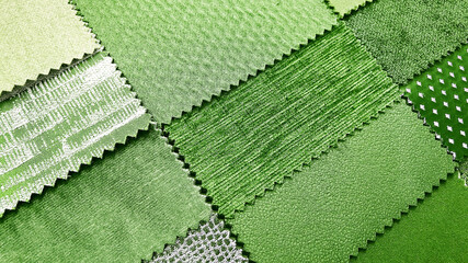 close up catalog of interior luxury fabric sample chart showing multi texture and pattern of fabric in bright green color tone. interior drapery and curtain samples palette for natural concept.