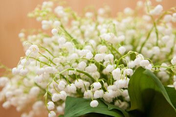 Bouquet of white lily of the valley flowers on wooden background with copy space, beautiful card	