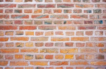 Old wall made of red bricks. Background with the surface of a brick wall.