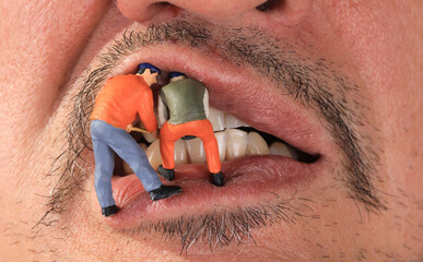 Small figure worker cleaning tooth model