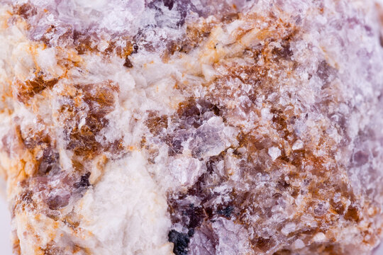 macro mineral lepidolite stone on a white background