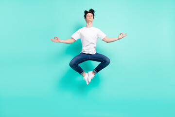 Full body photo of rest brunet hairdo teen guy jump do yoga wear t-shirt jeans isolated on teal background