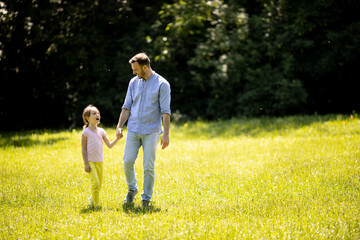 Father with daughter having fun on the grass at the park