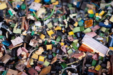A pile of small generic electronic waste painted on top with different colors and textures.