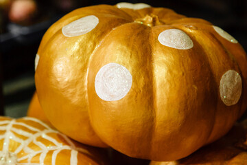 beautiful painted pumpkins of white and gold color on halloween