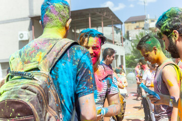the lots of people in the color fest, colored faces of the peoples, color festival in india