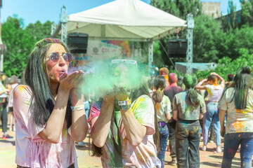 the pretty young womans in the color fest, colored face of the young womans, color festival in india