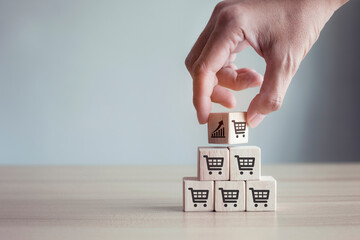 Hands flips cube with icon graph and shopping cart symbol, sale volume increase make business grow.
