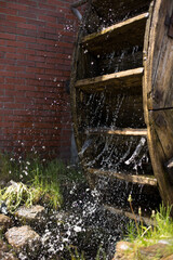 Watermill wheel under a rushing stream of water © anderus