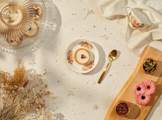 still life of small cream pies with gold spoon and tea cup