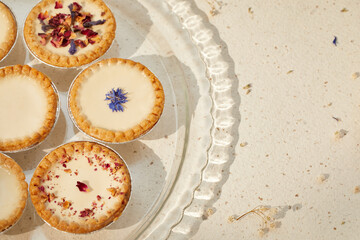 panna cotta pies with dried flowers in glass plate