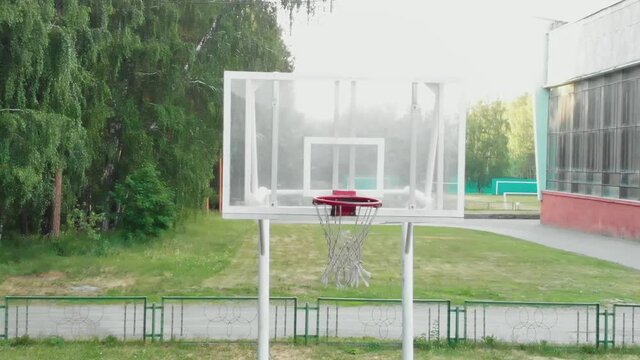 Throw in the basketball hoop. The ball flies spinning into the basket net. Sports concept. The winning throw. Street basketball. Basketball court