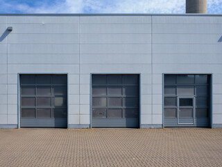 Truck doors in a workshop or loading docks. rolling gates for trucks. Facade of a warehouse or workshop.