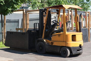 Forklift truck isolated. Hyster branded yellow forklift truck outside a factory industrial...