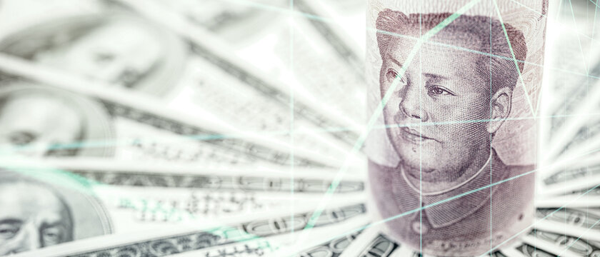 Chinese money banknote, 100 yuan banknote, surrounded by many hundred dollar bills. Concept of financial crisis between USA and China