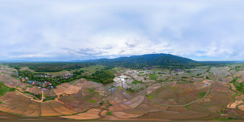 360 panorama by 180 degrees angle seamless panorama of aerial top view of paddy rice terraces with...
