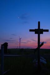 wind generators view from cemetery in evening time