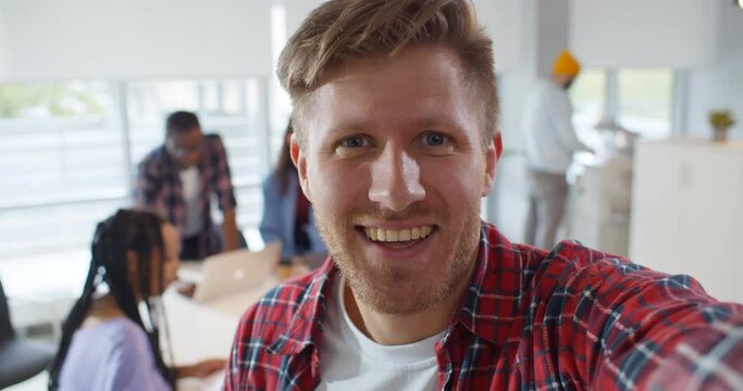 Hipster guy streaming video online working in creative office