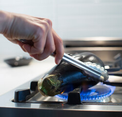 chef roasting aubergines on the fire