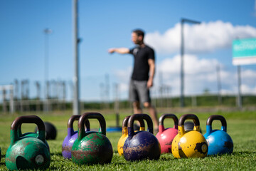 kettlebells in green grass - fitness concept outdoors 