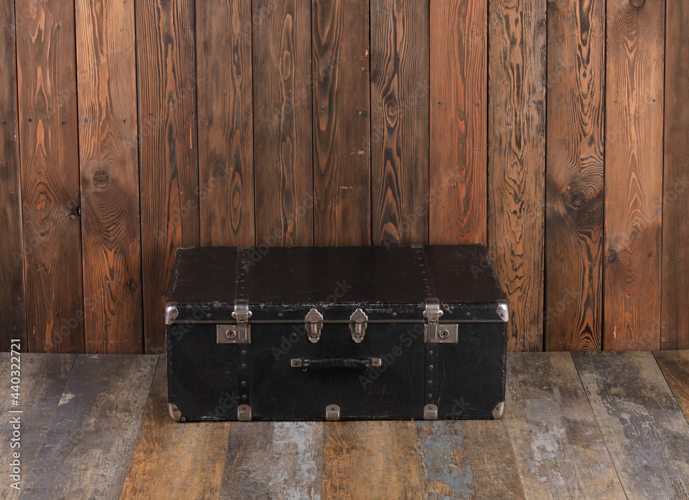 Sticker vintage black suitcase on wooden background