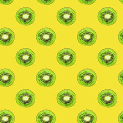Colorful pattern of ripe fresh pieces of kiki on a yellow background. Bright tropical background. Minimum summer concept. Flat lay.