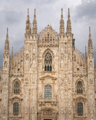 Fototapeta na wymiar Front view of Duomo with the golden statue name 