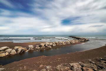 River mouth on the beach next to the jetty