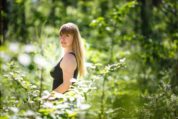 Naklejka na ściany i meble beautiful girl stands in thicket of forest