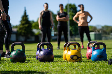Kettlebell weightlifting. Group training after a lockdown outside the city. Get in shape - 440323937