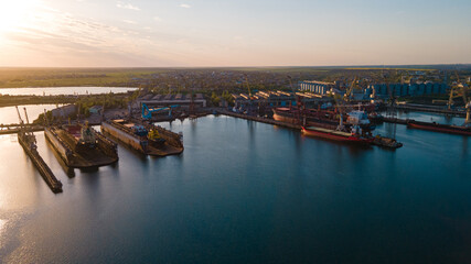 Naklejka premium Industrial port in the field of import-export global business logistics and transportation, Loading and unloading container ships, cargo transportation from a bird's eye view.