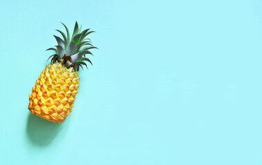 Yellow pineapple on a blue background. Exotic fruit.