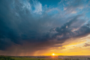 Fototapeta premium A beautiful sunset sky with stormy rainy sky panoramic view. Breathtaking moment of oncoming rain.