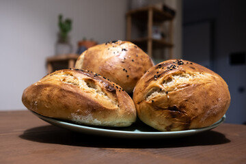 Homemade breads. Homemade organic breads on the plate. Mini breads made with whole wheat flour. Selective focus.