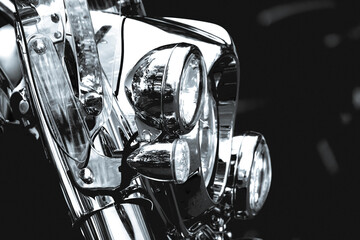 Chrome headlights of a classic chopper motorbike in black and white