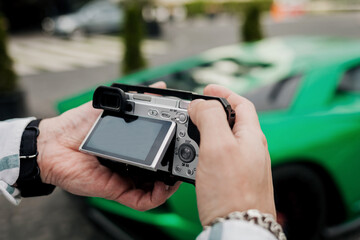 man holds a digital camera