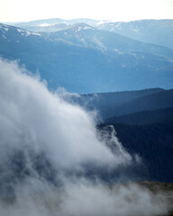 Naklejka premium The fog rises over the mountains after the rain